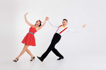 Full size photo of two elegant young people hold hands dance isolated on white color background