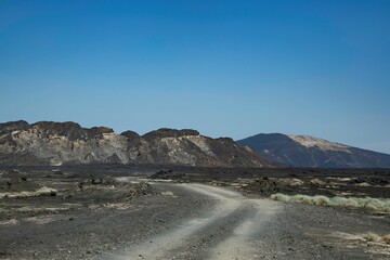 Road through the remote volcanic landscape of the Afar region in Ethiopia