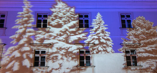 Christmas video projection on old building wall at night