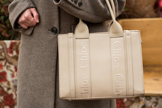 Mulhouse - France - 24 december 2024 - closeup of brown leather hand bag by chloe in hand of woman in the street