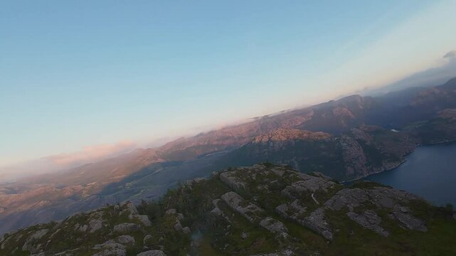 Diving a beautiful mountain crest over Rambergstranda Beach at sunset, Lofoten Islands in Norway. Preikestolen.