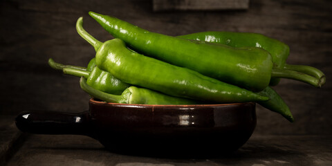 Fresh raw green peppers on table, genuine food ingredients, agricultural concept
