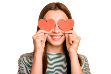 Photo of shy girl hiding her eyes behind paper reddish hearts while isolated with yellow background
