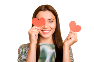 Photo of cute playful girl looking out of one hearts given her as present for valentine day while isolated with yellow background