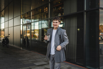 Fototapeta premium man drink coffee while go to break from work around modern buildings