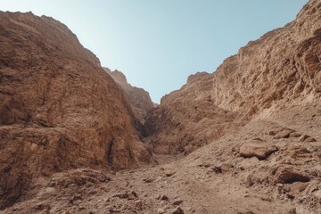 A Stunning Desert Canyon: Exploring the Rugged Beauty of the Earth's Landscape.  A Breathtaking View of the Arid Valley and Dramatic Mountains. An Adventure into the Heart of Nature.