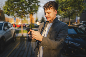 Fototapeta premium young man use mobile phone in the parking lot