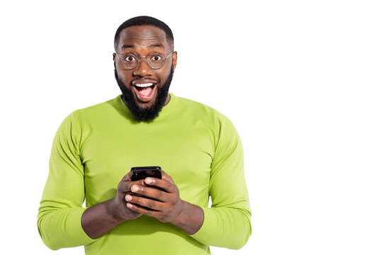 Portrait of funny guy holding device texting typing screaming wow omg wearing eyeglasses eyewear isolated over white background