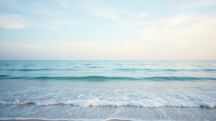 Fototapeta premium Serene Coastal Scene Gentle Waves Lap the Shore Under a Calm Sky