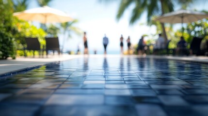 Obraz premium Serene Poolside Scene with Reflections and Lush Tropical Background Illuminated by Bright Sunlight, Perfect for Vacation Imagery and Relaxation Themes