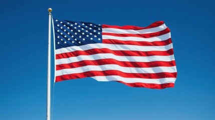 Fototapeta premium American Flag Waving in Clear Blue Sky with Bright Sunlight