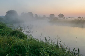 misty morning on the river in village