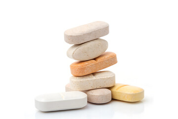 Colorful Assorted Tablets on White Background - Vibrant Medicine Stack