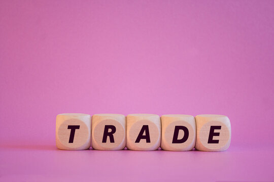Trade symbol. Wooden cubes with word Trade. Beautiful purple background. Business concept. - Powered by Adobe