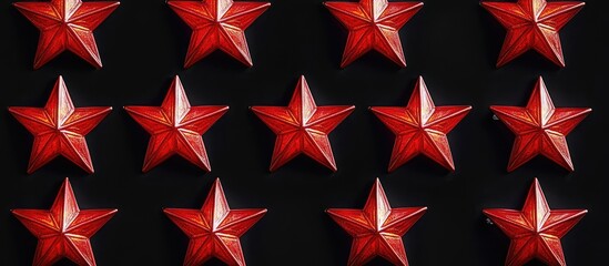 Obraz premium Red five pointed star lamps in uniform rows against a black background creating a striking decorative pattern.