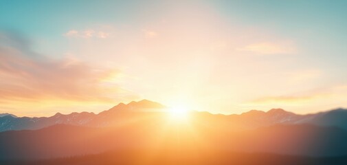 Obraz premium A serene sunrise over mountains, casting warm hues of orange and yellow into a clear sky, creating a tranquil and picturesque landscape.