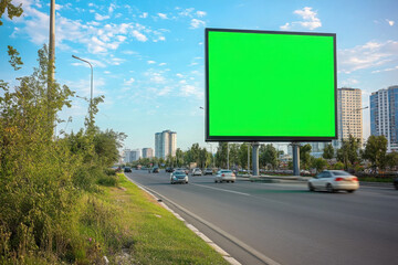 Blank billboard with chroma key green screen copy for your text on a street.