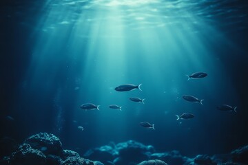 Fototapeta premium Underwater View of Fish Swimming in a Serene Ocean Environment With Rays of Sunlight Breaking Through Clear Water