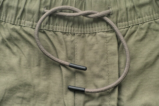 Close up shot of shorts with  drawstring waistband.