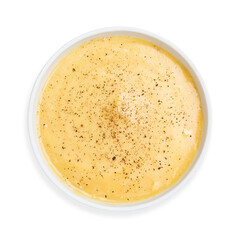 Cheese cream soup with black pepper, on a white background, isolated. Top view.
