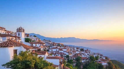 Naklejka premium Serene Sunset Over Whitewashed Village with Mountains in Background