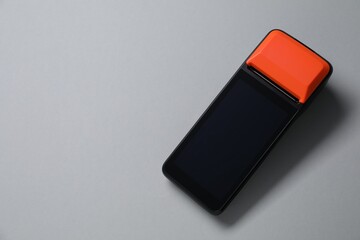 One payment terminal on grey background, top view. Space for text