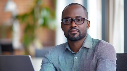 Entrepreneur brainstorming new digital marketing strategies using a laptop in a clean, modern office