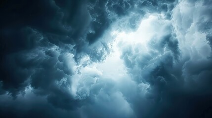 Obraz premium Dramatic dark storm clouds with a bright center.