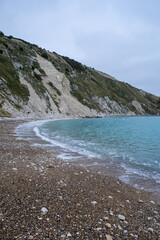 Lulworth Cove and beach view at winter day. Lulworth Cove bay, beach and cliffs view . The Jurassic Coast is a World Heritage Site on the English Channel coast of southern England. Dorset, UK. public 