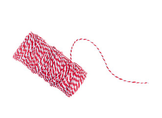 christmas red and white bakers twine rope spool isolated on white background. Packaging equipment...