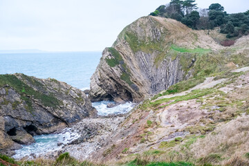 Jurassic coast view in Dorset. Cold winter day. Lulworth Cove cliffs view on a way to Durdle Door. The Jurassic Coast is a World Heritage Site on the English Channel coast. Stair Hole view