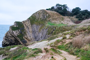 Jurassic coast view in Dorset. Cold winter day. Lulworth Cove cliffs view on a way to Durdle Door. The Jurassic Coast is a World Heritage Site on the English Channel coast. Stair Hole view