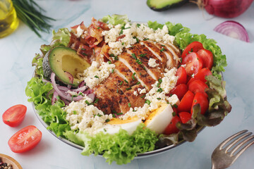 A bowl with cobb salad, traditional American dish