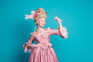 Photo of lovely positive lady wearing queen costume corset dress showing strong arm isolated on blue color background