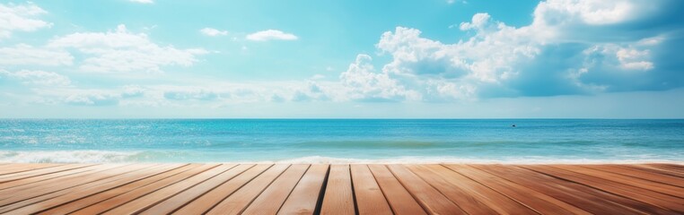 Fototapeta premium Wooden deck overlooking a serene ocean view with clear skies and white clouds in the distance near the beach at midday
