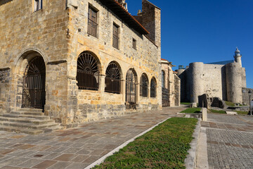 Santa Mar&iacute;a de la Asunci&oacute;n church and the castle - lighthouse in the beautiful village of Castro Urdiales in a sunny day. Cantabria, Spain.