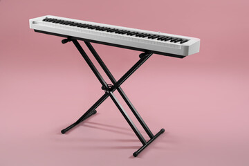 Synthesizer on pink background. Electronic musical instrument