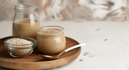 Jars of tasty tahini on table