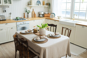 Scandinavian classic minimalistic kitchen with white and wooden details flowers. Modern white kitchen clean contemporary style interior design. Empty bright white interior minimal of kitchen