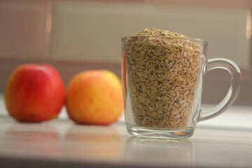 Glass with oatmeal against the background of apples healthy eating,5