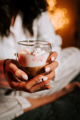 Enjoying a Cozy Cappuccino With Marshmallows in Bed Next to a Beautifully Decorated Christmas Tree
