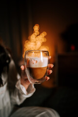 Enjoying Cappuccino With Marshmallows in Bed Surrounded by a Festive Christmas Tree and Warm Garlands