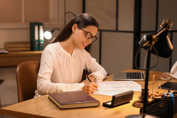 Female lawyer working in office at night