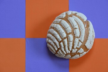 Mexican sweet bread on mosaic background with copy space.