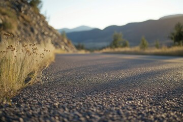 A paved road leading to a mountain in the background