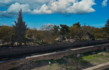 Ancient Agora of Athens with Railway Track and Ruins Under a Cloudy Sky..