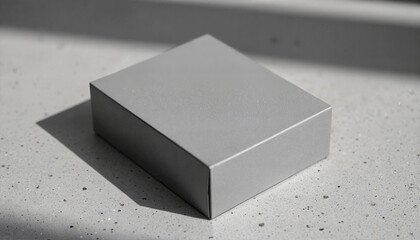 Mockup of matte gray square box with soft shadow on concrete surface