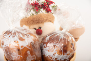 Mini panettone, mini panettone in a basket, placed on a white surface with a white background, selective focus.