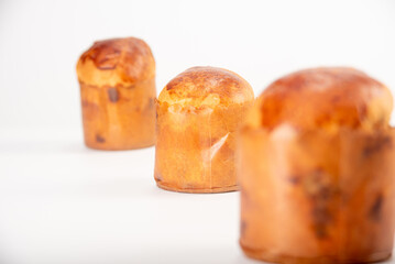 Mini panettone, mini panettone placed on a white surface with a white background, selective focus.