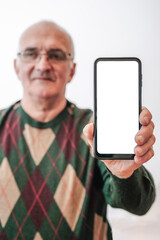 Old Man holding screen smartphone on empty white background. 